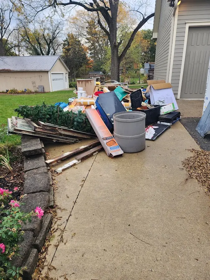 Dumpster being loaded with debris for 12 Yard Dumpster Rental in Bellflower